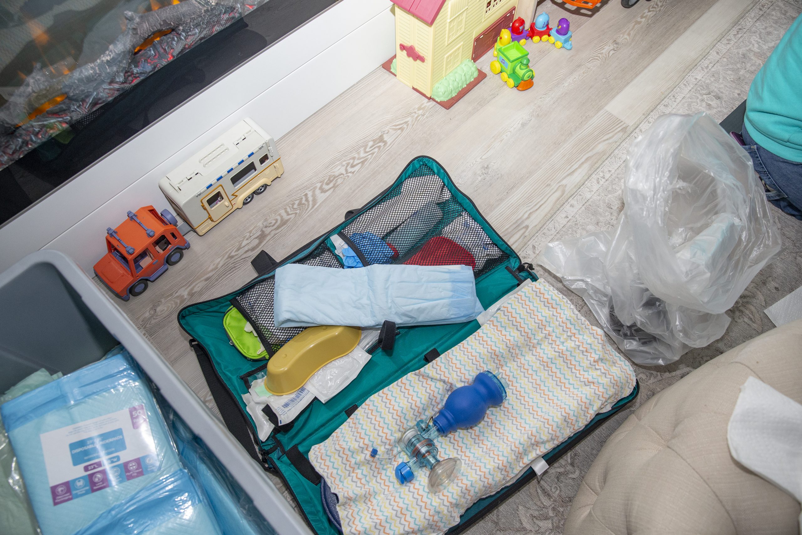 Birthing and medical supplies lie among toys during a home birth Dec. 5, 2022, in Riverside.