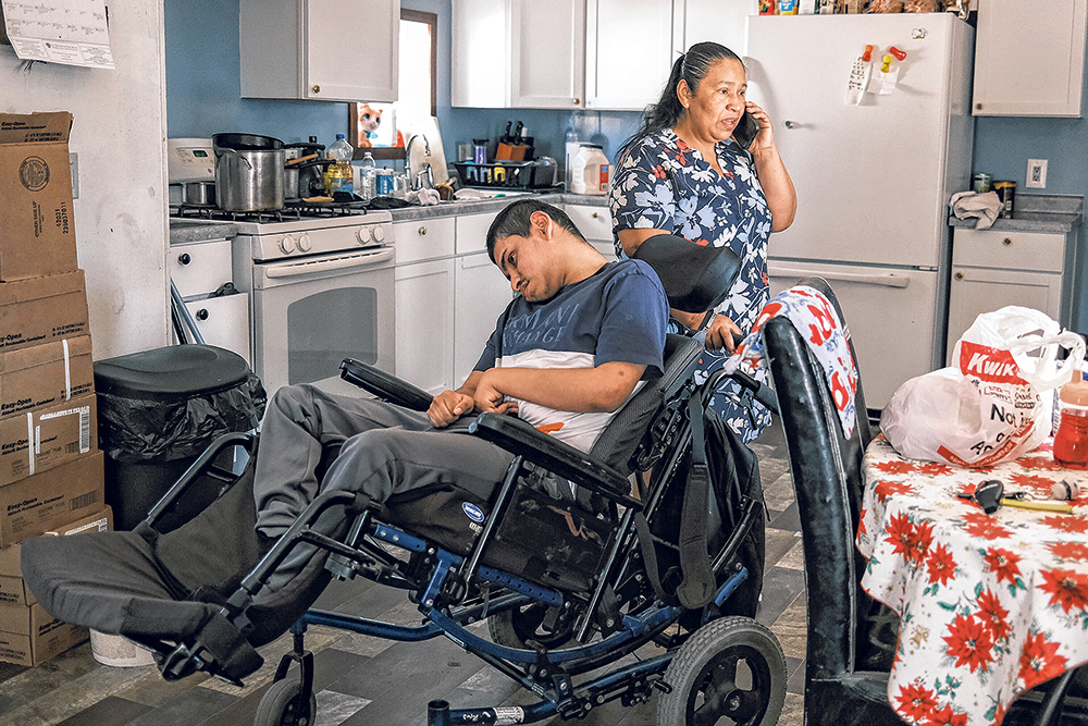 Maria Davila Hererra speaks with an immigration attorney April 12 at her home in Iowa City while caring for her son, Christian Davila Reconco.