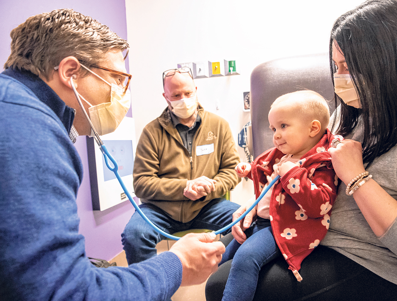Staff physician Dr. Mike Halyko listens to the heartbeat of 15-month-old Devyn Kaas during an appointment at the Stead Family Children’s Hospital in Iowa City