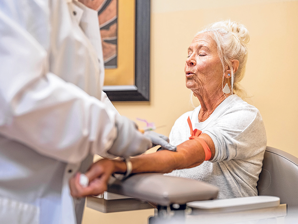 Diane Anderson prepares for her blood to be drawn to make sure her breast cancer still is in remission.
