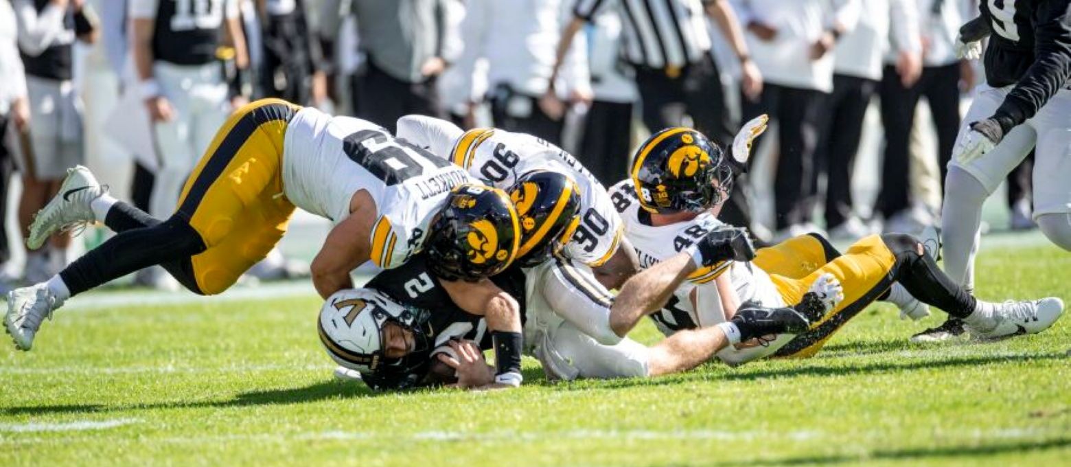 Iowa Hawkeyes defensive lineman Ethan Hurkett (49) sacks Vanderbilt quarterback Diego Pavia (2) during the 2025 ReliaQuest Bowl